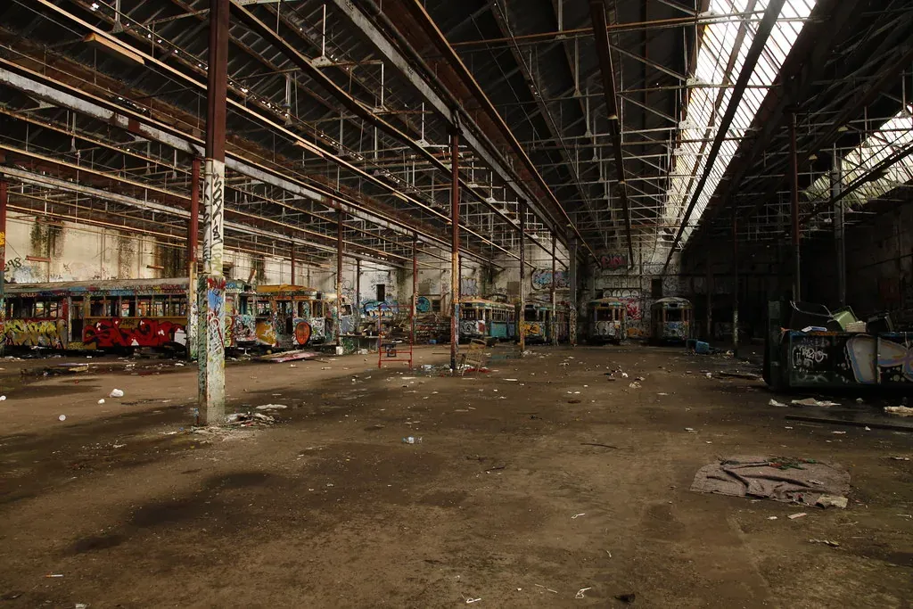 The former Rozelle tram depot before restoration, with an open industrial interior and graffiti.